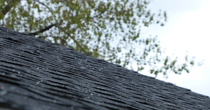 Hail falling on an asphalt rooftop