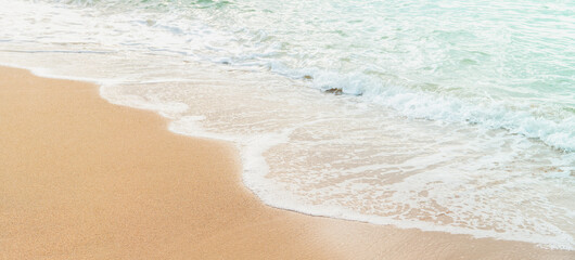 Ocean wave on sand beach background for summer vacation concept.