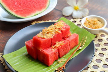 Watermelon with Sweet Dried Fish Crispy Shallot Dip - Thai Authentic appetizer food called Pla Hang Tangmo at close up view