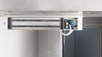 Instalation Magnetic lock system on the door for control of security system.