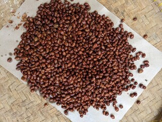 tasty fried peeled peanuts placed in a traditional bamboo container