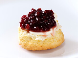 Tokyo, Japan - May 1, 2023: Closeup of a scone and clotted cream and jam on white background
 - obrazy, fototapety, plakaty