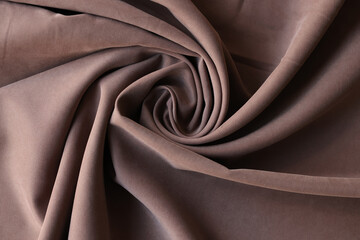 Naklejka na ściany i meble Twisted brown textile with creases for curtain production