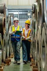 Factory apprenticeship. Man mentor teaching Female employees trainee operating machine looking...