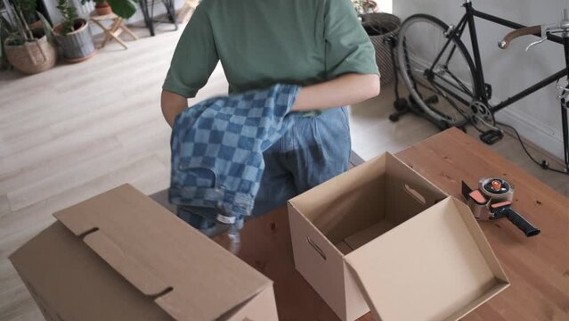 Top view of fashion designer packing clothes in cardboard boxes delivering products Generative AI