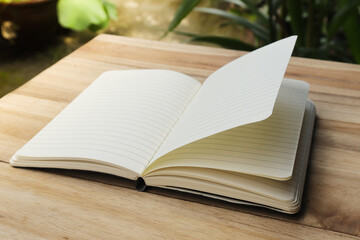 Close up of empty note book on wooden table during the day