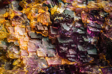 yellow and purple fluorite cubic structure. macro detail texture background. close-up raw rough...