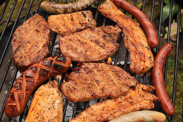 various meat and sausages on the charcoal grill