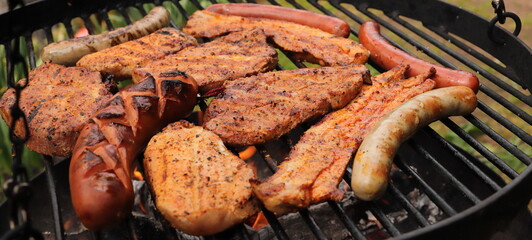 various meat and sausages on the charcoal grill