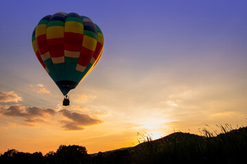 Hot air balloons flying over the  valley on sunset in summer time