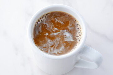 淹れたてのフレッシュなコーヒーにクリームを入れる