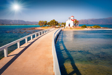 Sunny summer view of Saint Spiridon church in Elafonisos port. Attractive morning seascape of Mediterranean Sea. Spectacular outdoor scene of Elafonisos island, Greece, Europe.