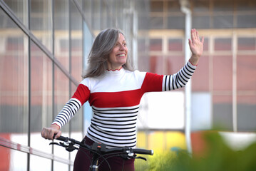 Cheerful middle-aged woman rides bicycles, recreation every day