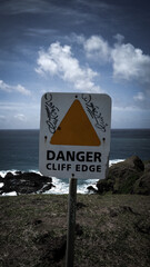 sign at the edge of cliff in Lombok Island, Indonesia