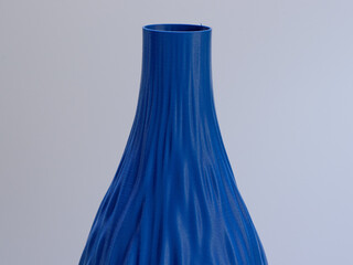 3D printed vase with a fabric like abstract surface and made from cobalt blue thermoplastic