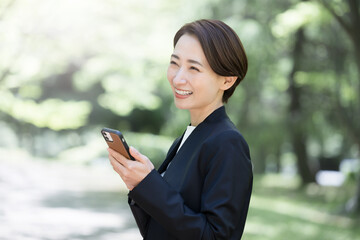 Woman holding with a smartphone in a suit Changing jobs, hiring, appointing women in the business world, etc.