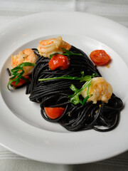 Spaghetti al Nero di Seppia con Gamberi, Italian Pasta with Squid Ink, Prawns, Tomato and Rucola