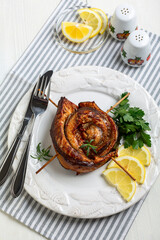 Baked mackerel fillet in the form of a roll.
