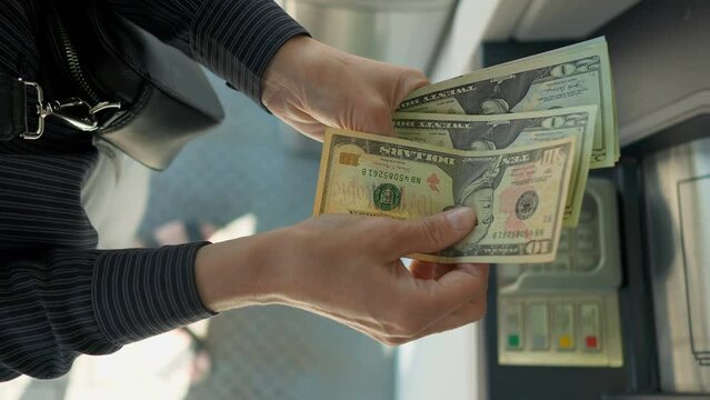 Business woman counting us dollars near ATM machine  Generative AI