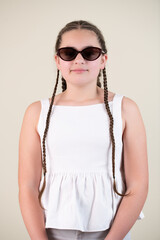 young girl with pigtails and sunglasses