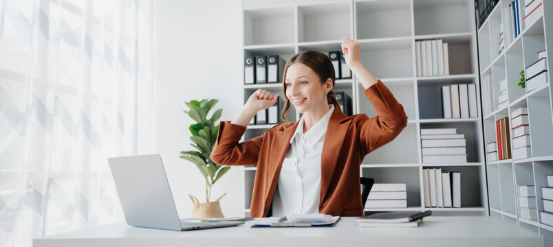  business woman are delighted and happy with the work they do on their tablet, laptop and taking notes