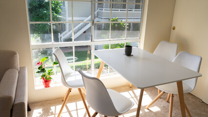 Dining room area with table, chairs and large window