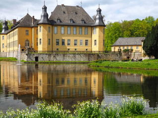 Fototapeta na wymiar Romantic yellow water castle Schloss Dyck in Juechen in Germany