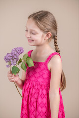 Little girl Holding Violet lilac Flowers