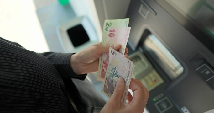 Business woman counting turkish lira near ATM machine  Generative AI