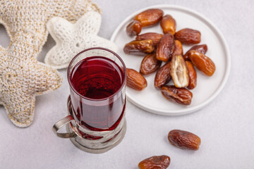 Hibiscus hot tea with dates. Traditional Ramadan Kareem concept snack for Iftar or Suhoor meal