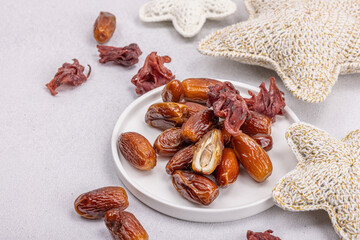 Ripe dates, traditional Ramadan Kareem concept snack for Iftar or Suhoor meal on a light background