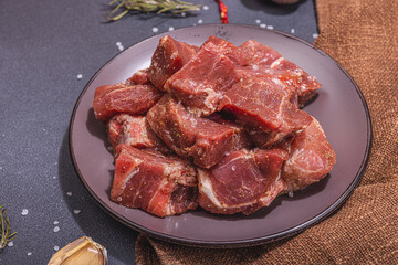 Raw pork loin pieces with ground spices. Marinated meat cuts, ingredient for cooking healthy food