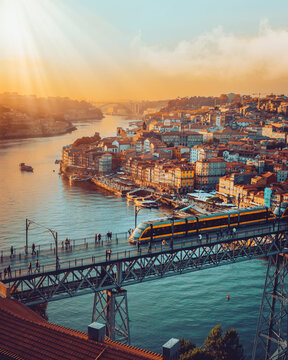 Porto, Portugal Dom Luis Iron Bridge at sunset featuring Douro River, Metro Train and Port Wine Boats 