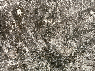 The surface of the old cement wall with a beautiful pattern is very unusual in black and white.