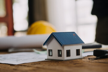 Construction and structure concept of Engineer or architect meeting for project working with partner and engineering tools on model building and blueprint in working site, contract for both companies.