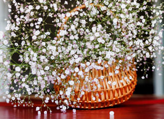 bouquet of gispophiles in a wicker basket on the table