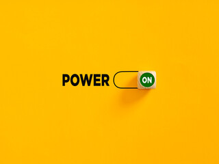 Power on slider button on yellow background. Power and motivation concept.