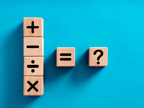 Basic mathematical operations symbols. Plus, minus, multiply, divide, equal and question mark symbols on wooden cubes.
