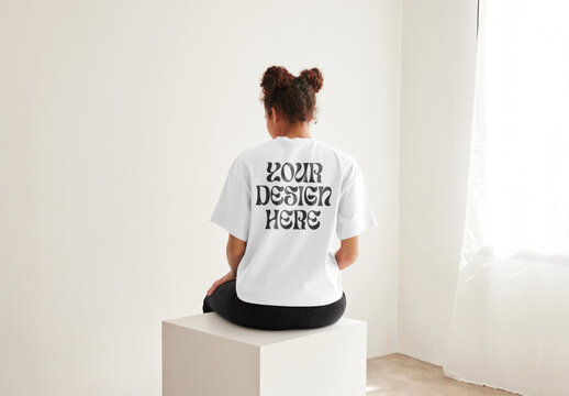 Mockup of customizable t shirt being modelled by woman, rear view