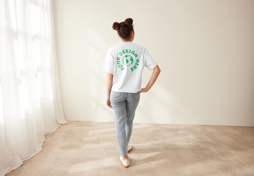 Mockup of customizable t shirt being modelled by woman, rear view