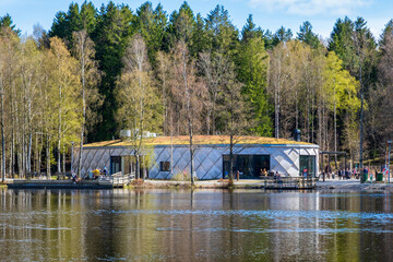 Local cafe next to a lake meant for social gathering during sunny spring day in Gothenburg Sweden