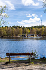 Fototapeta na wymiar Local cafe next to a lake meant for social gathering during sunny spring day in Gothenburg Sweden with a bench to relax