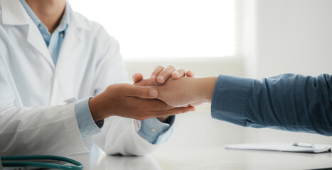 A medical professional in a white coat talks to discuss results or symptoms and guide male patients and sign medical documents at the next clinic appointment.