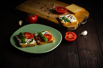 Cooking sandwiches with vegetables for breakfast together at wooden table.