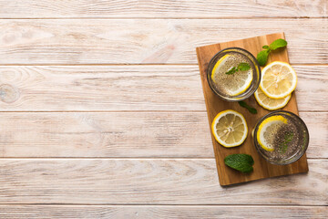 Healthy breakfast or morning with chia seeds lemon and mint on table background, vegetarian food, diet and health concept. Chia pudding with lemon and mint