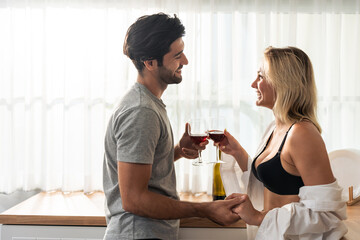 Caucasian young hot sexy couple clinking and drinking a glass of beer. 