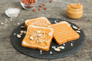 Peanut butter sandwiches or toasts on light table background.Breakfast. Vegetarian food. American cuisine top view vith copy space