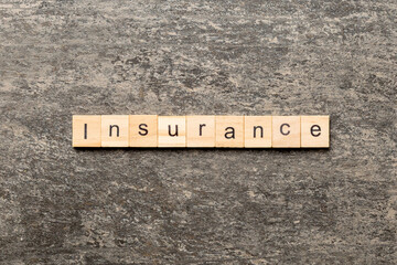 insurance word written on wood block. insurance text on table, concept