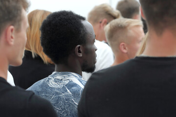 cropped image of a youth group pointing up.