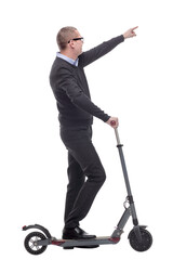 Full length portrait of an young businessman riding a scooter and pointed at camera